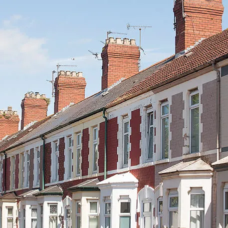 Row of terraced houses with red brick and painted elevations