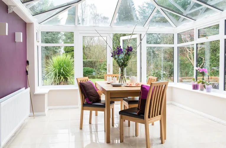 Everest conservatory with white frames and purple accents