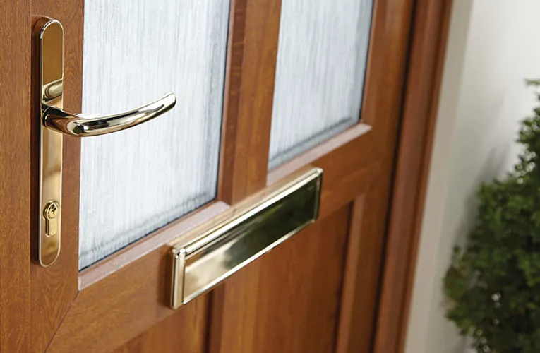 Wooden door with gold hardware and frosted glass