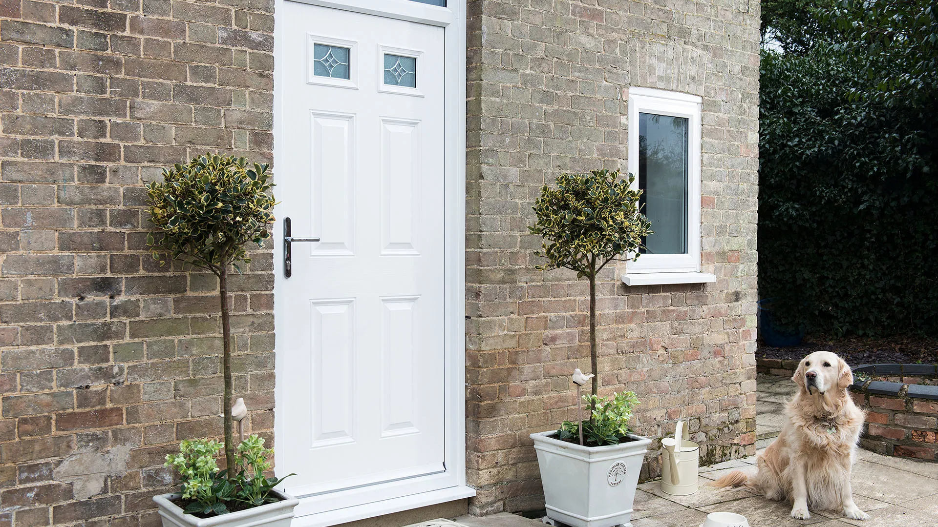 White Everest door with brick wall and plants