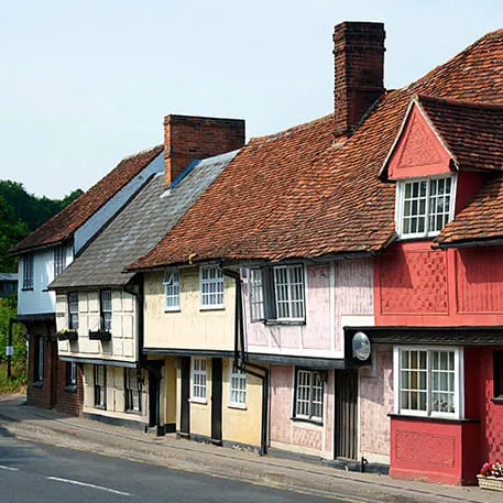 Row of historic buildings with terracotta roofs and colourful facades