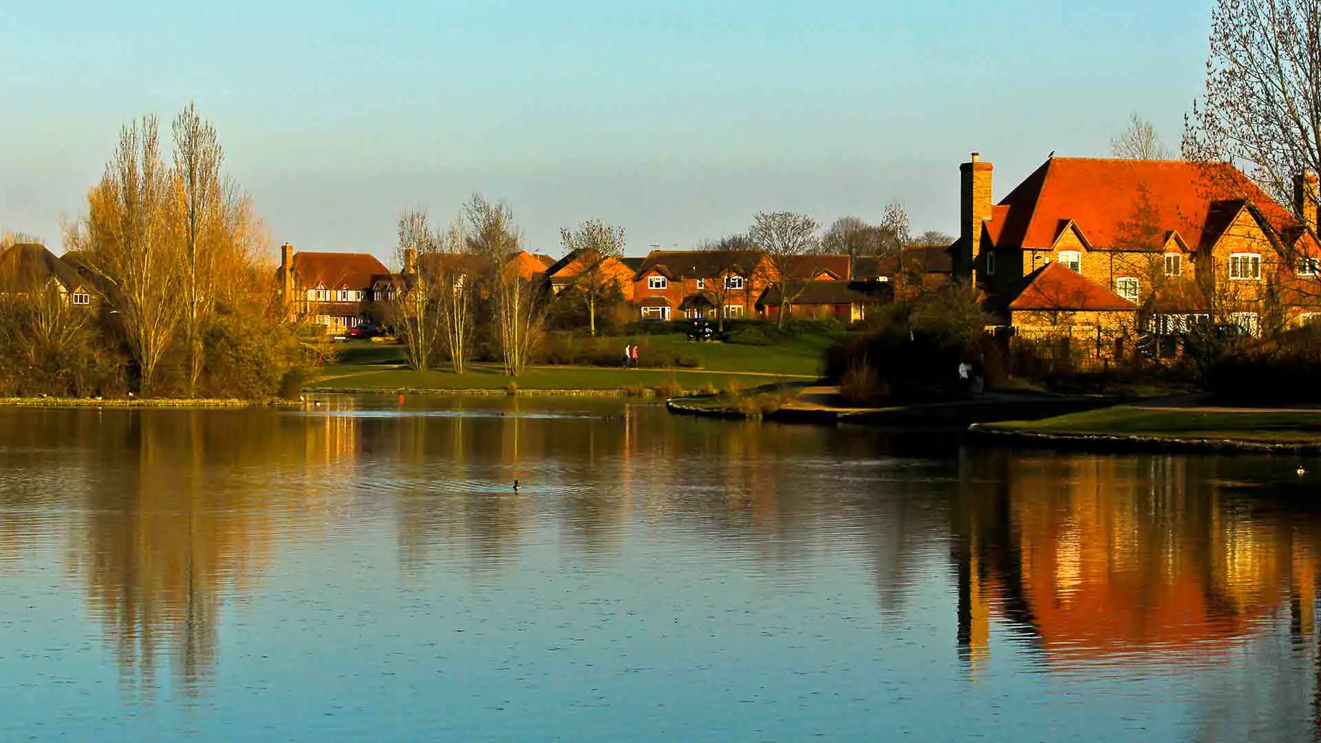 Houses reflected in a calm lake