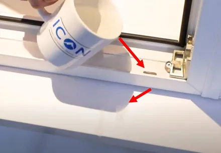 White window frame with water being poured