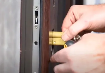 Hands inserting key into door lock