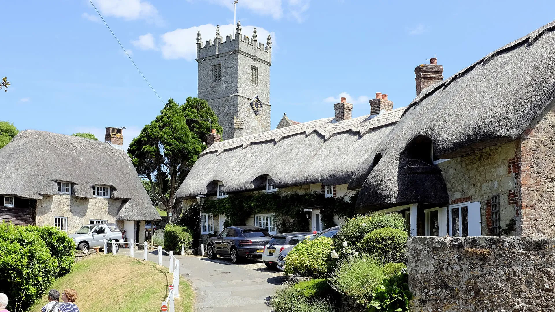 Thatched cottages and church in a village setting