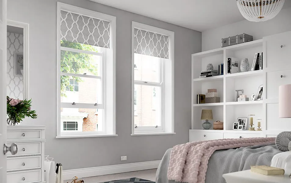 Light gray walls with white window frames and gray patterned window coverings