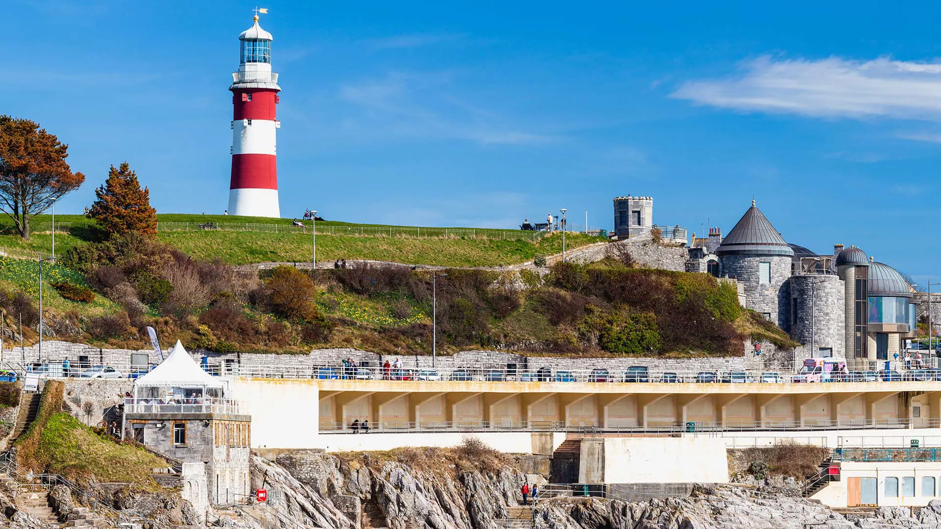 Coastal scene with red and white lighthouse