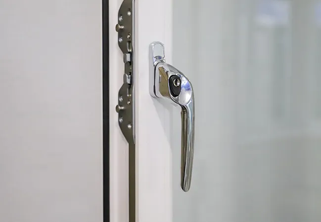 Chrome window handle on white Everest conservatory