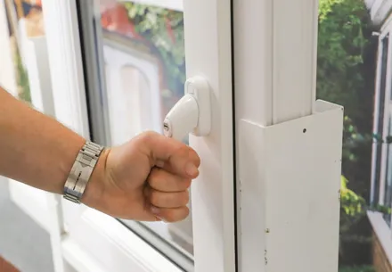 Person opening a white Everest conservatory window
