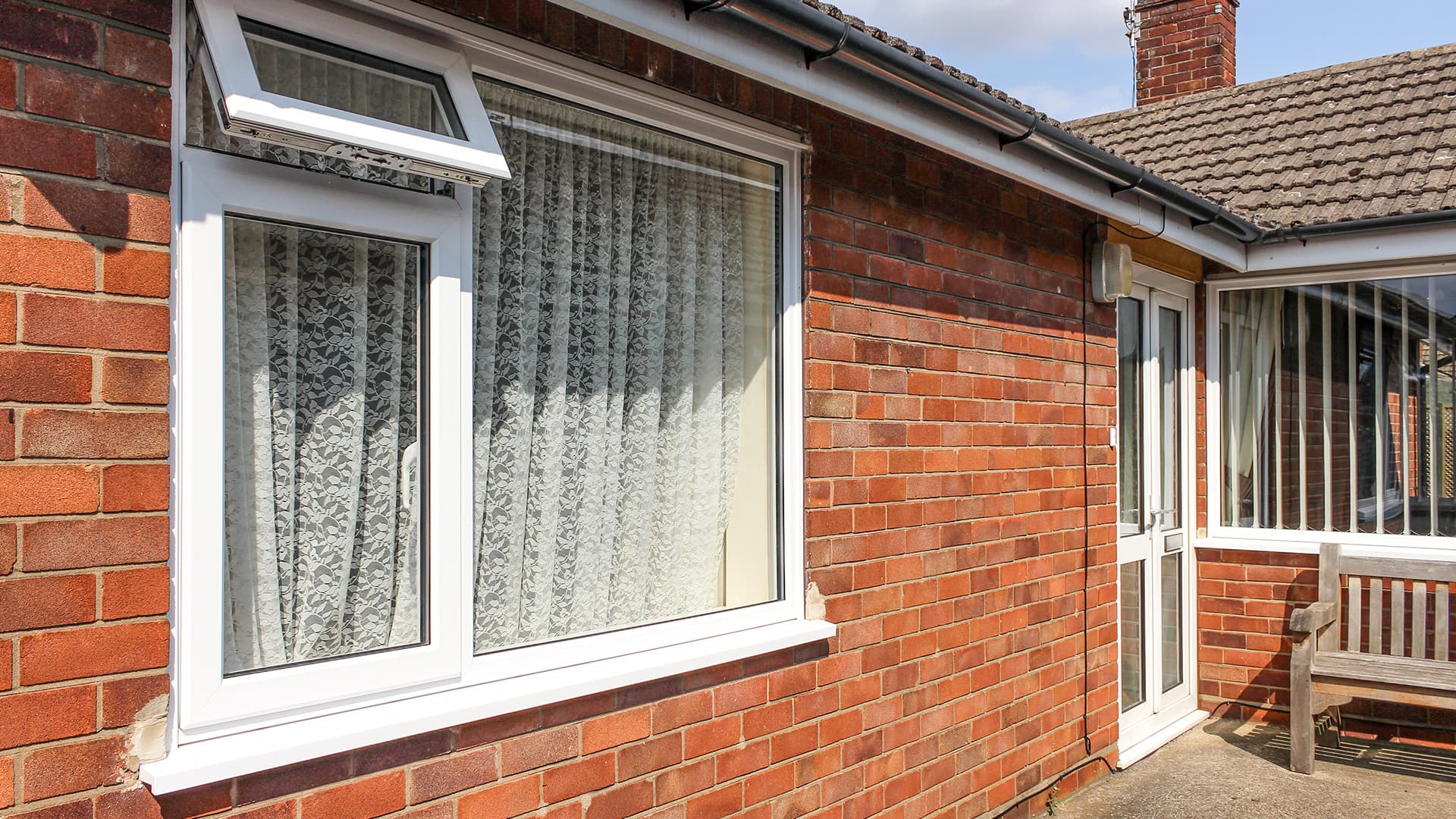 White Everest conservatory window with lace curtains
