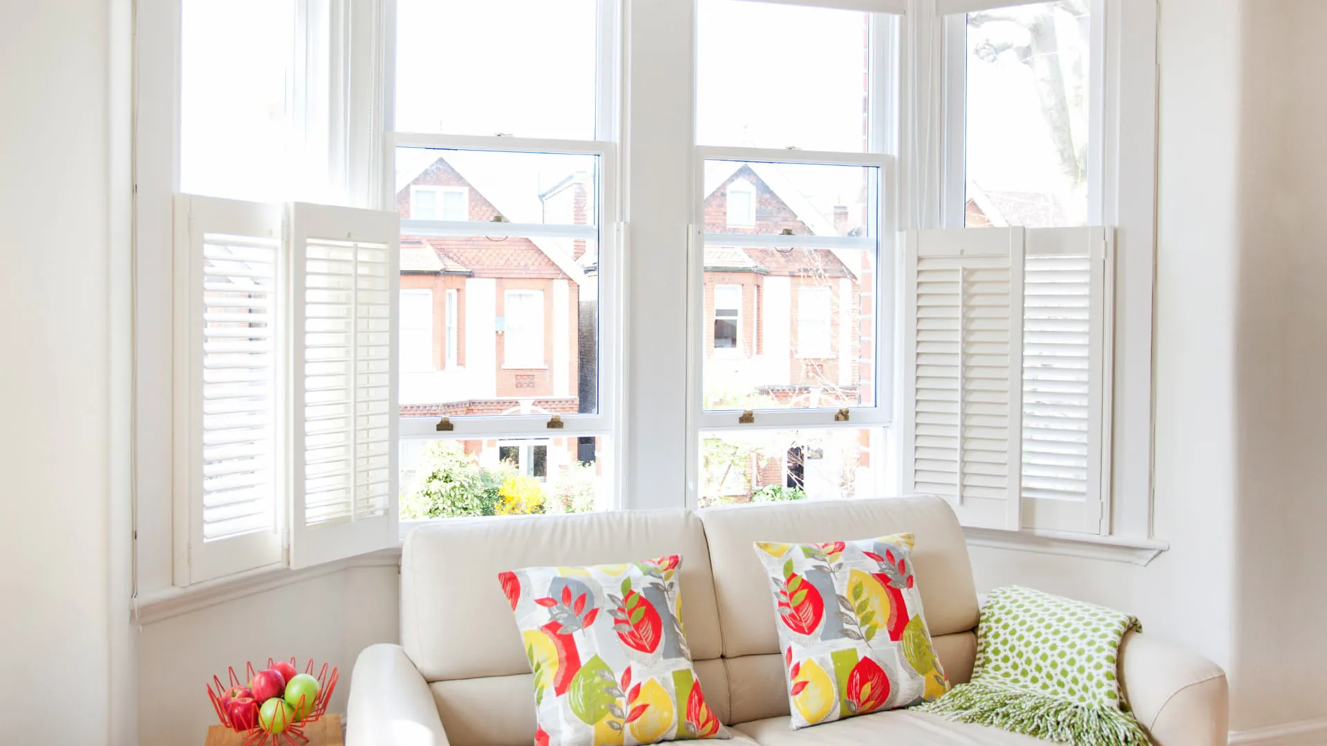 White shutters and window Everest conservatory with colorful cushions