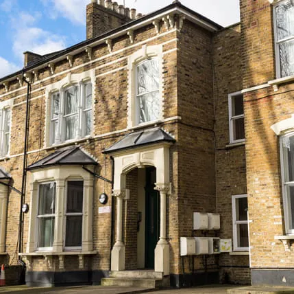 Terraced house entrance with cream coloured porch