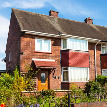 Brick house with red tiled bay window