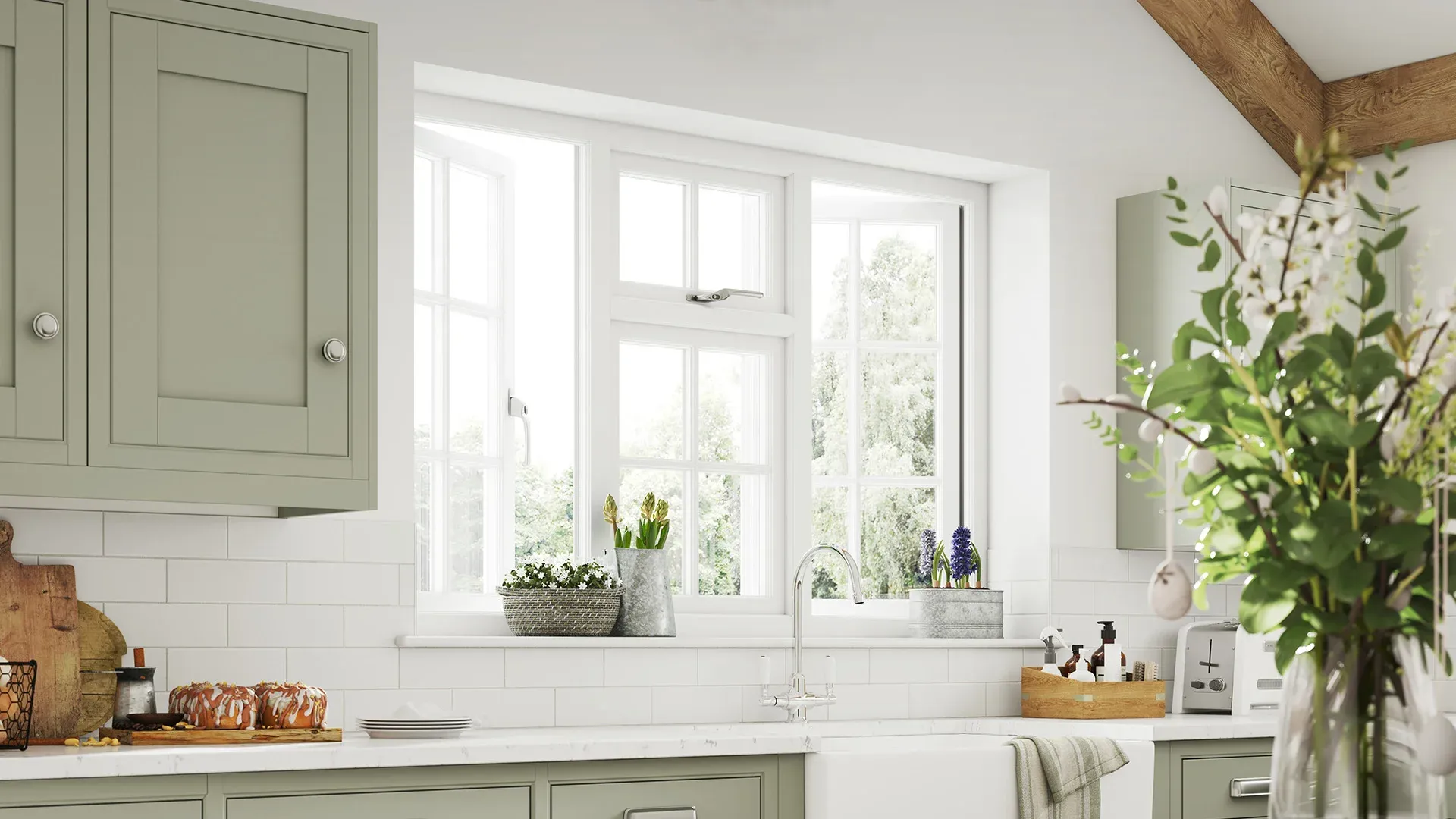 Sage green kitchen cabinets with white window and flowers