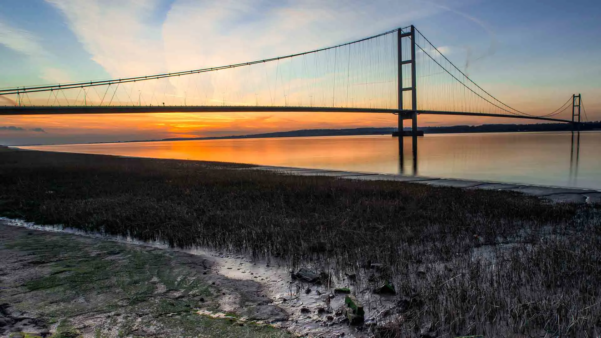 Sunrise over a bridge over a river
