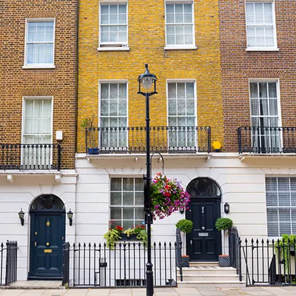 Elegant terraced house with yellow and brown brickwork and white stucco