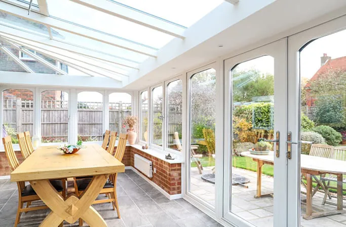 Everest conservatory with white frames and wooden furniture