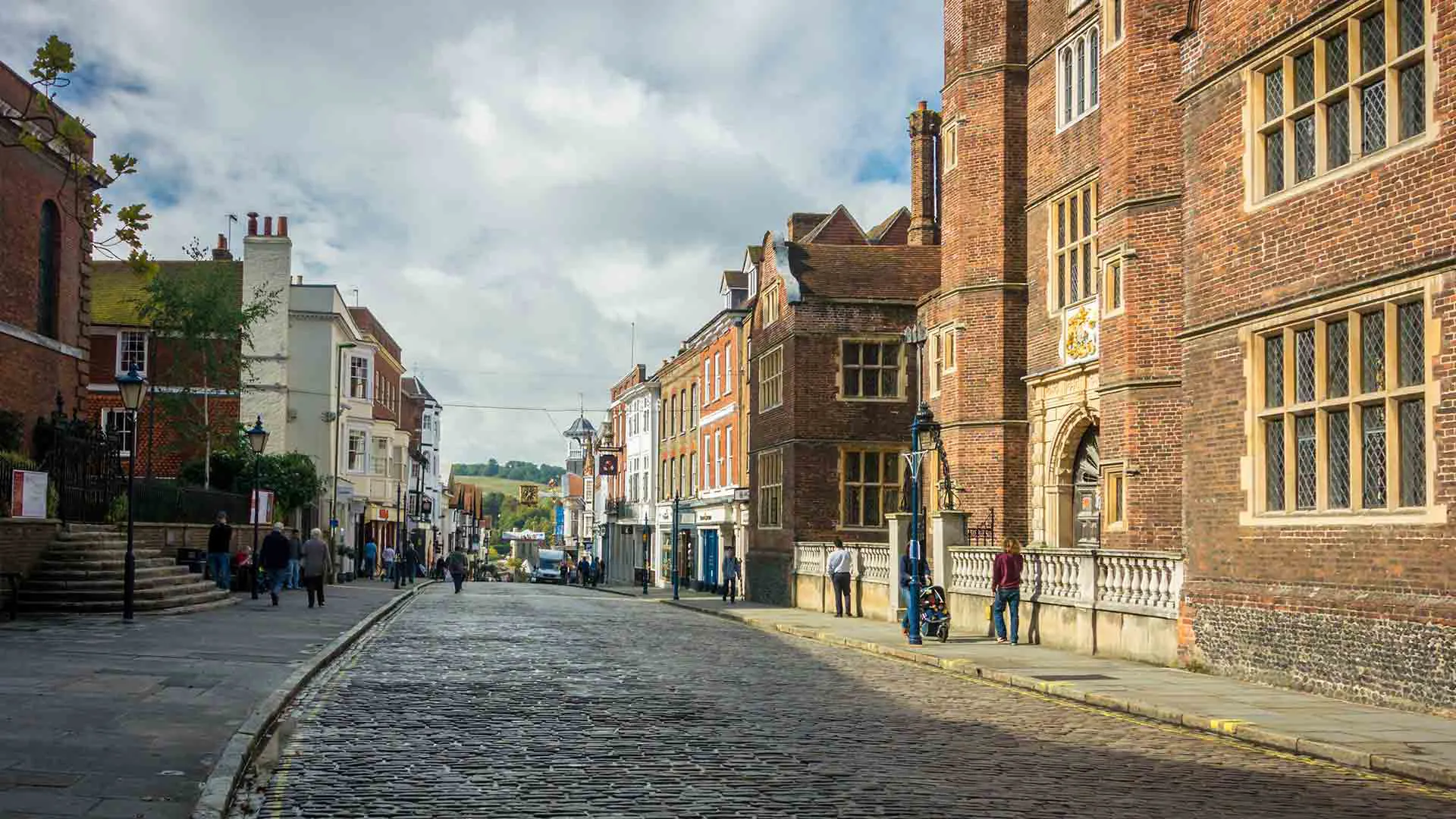 Cobblestone street with buildings and pedestrians